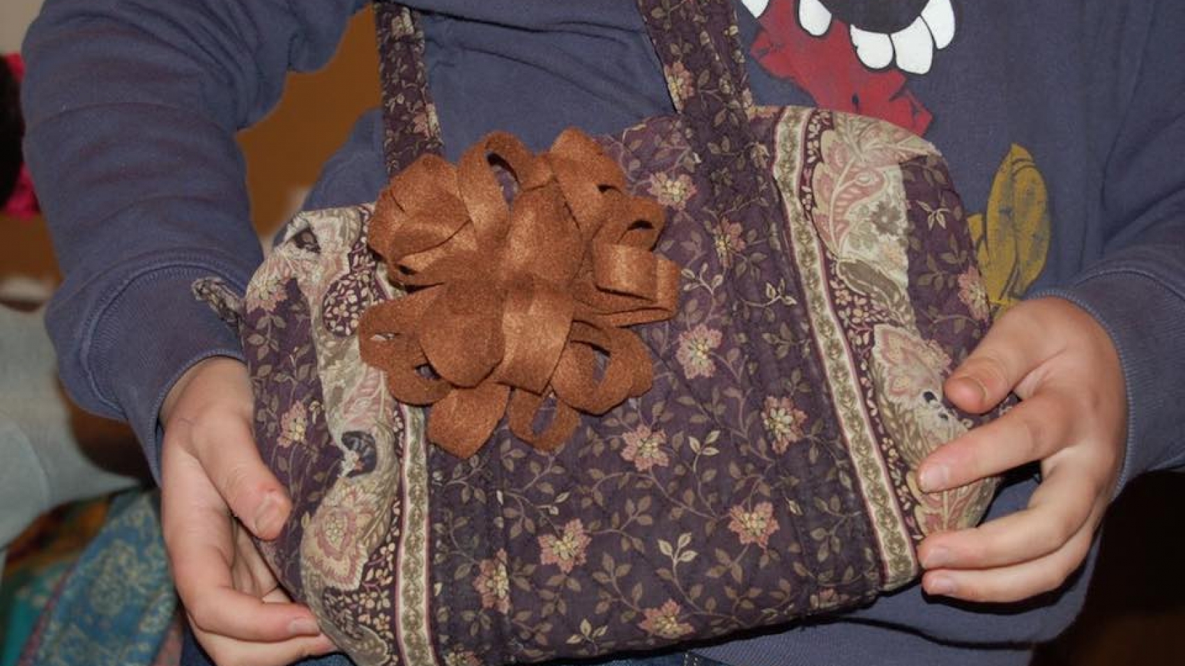 felt flower attached to a bag