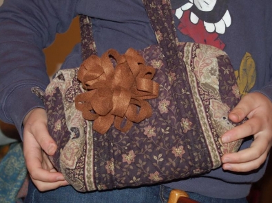 felt flower attached to a bag