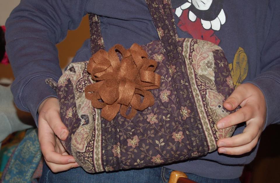 felt flower attached to a bag