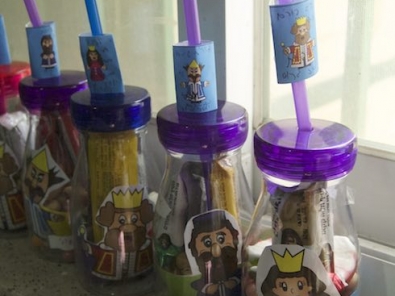 purim bottles with purim character cupcake wrappers and chocolate wrappers via birkat chaverim
